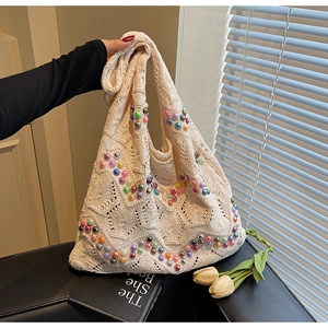 Detailed close-up of handmade cream crochet tote bag with vibrant multicolored beads