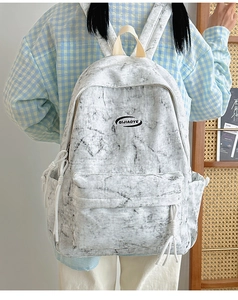Fashionable marble pattern backpack featuring a front zipper pocket and side drawstrings