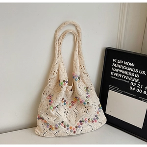 Macro detail of bohemian hollow knit tote bag with colorful beads and diamond texture