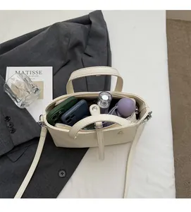 Top view of cream bucket bag interior showing capacity for phones and umbrella