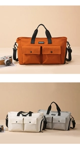Detail view of multi-pocket travel bag with dual handles and adjustable shoulder strap