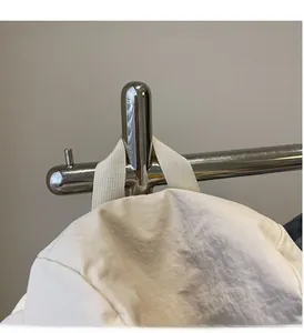 Close-up of the reinforced woven handle and durable nylon fabric of the white tote bag