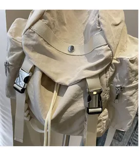 Detailed view of lightweight nylon backpack texture with metal zippers and buckles