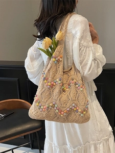 Knitted hollow tote bag with colorful beads and beige crochet design for beach vacation