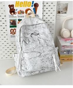 Close-up of marble texture canvas backpack with woven rope zipper and side pocket