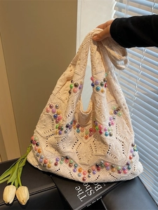 Handcrafted beige knit tote bag with colorful faux pearls and cutout crochet texture