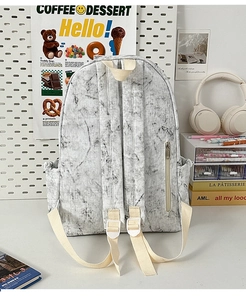 Detail of backpack back with marble pattern, shoulder straps and hidden zipper pocket