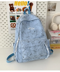 Detail of blue marble pattern backpack with side pockets and smooth zippers