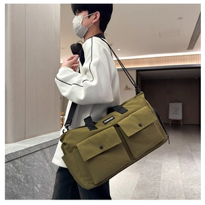 Olive green travel duffel with large front flap pockets and adjustable shoulder strap