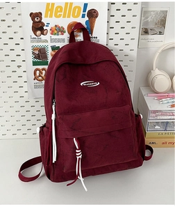 Detail view of burgundy campus backpack with white logo and decorative zipper pulls