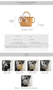 Detail view of mini bucket bag with pearl ribbon charm and litchi pattern PU leather