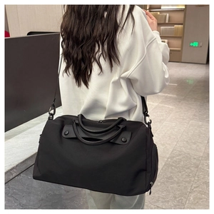 Detail of black waterproof fitness bag with leather handles and adjustable strap