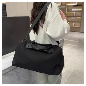 Close-up of durable black gym bag with reinforced faux leather handles and zip details