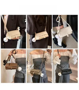 Crossbody rectangle bag with fur pompom charm shown on models in four colors