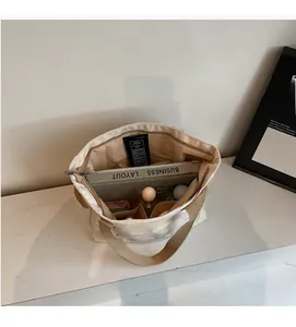 Interior view of beige canvas tote bag showing spacious compartments and storage capacity