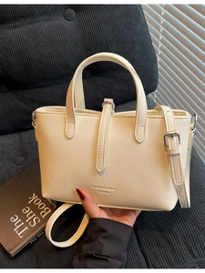 Vintage beige lychee pattern bucket bag with double handles and adjustable strap