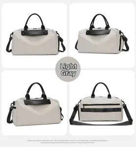 Light gray fitness bag featuring waterproof canvas material and trolley strap detail