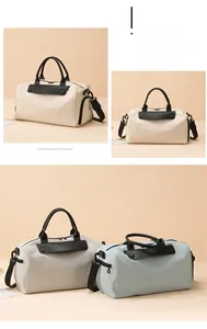 Detail of canvas travel bag with leather handles and adjustable shoulder strap
