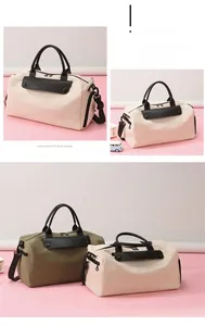 Detail view of canvas travel bag with leather handles and metallic zipper hardware