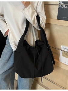 Minimalist black large capacity canvas shoulder bag with drawstring closure for women