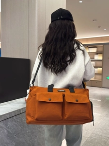 Large orange travel bag with wet-dry separation and durable handles for short trips