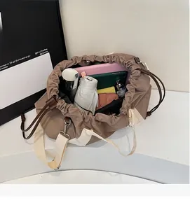 Detailed view of the khaki tote bag spacious interior with umbrella and tablet inside