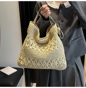 Détail du sac cabas en paille crochetée avec fleurs et bandoulière géométrique colorée