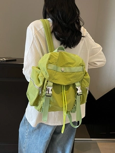 Lime green nylon backpack with front buckles and side pockets for travel or school
