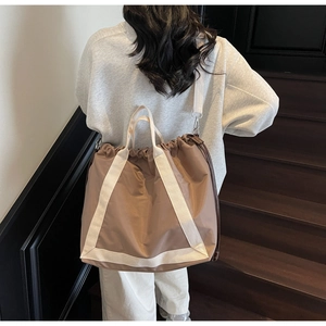 Close-up of contrast drawstring tote bag with reinforced wide webbing and large capacity