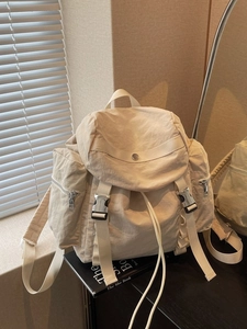 Minimalist cream nylon backpack for school and yoga with buckle closures and side pockets