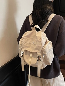 Minimalist cream nylon backpack with flap closure and buckles for casual daily use