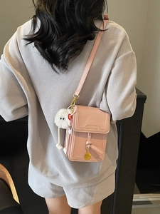 Pink PU leather crossbody phone bag for women with fashionable plush pendant and gold charm