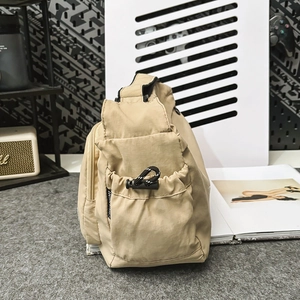 Detail of nylon bag side pocket with black drawstring and smooth waterproof texture