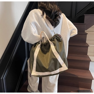 Army green nylon tote bag featuring drawstring closure and off-white shoulder straps