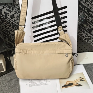 Detail view of khaki nylon crossbody bag showing durable texture and adjustable strap