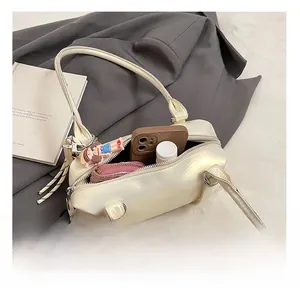 Top-down view showing interior storage capacity of a cream shoulder bag with zipper closure