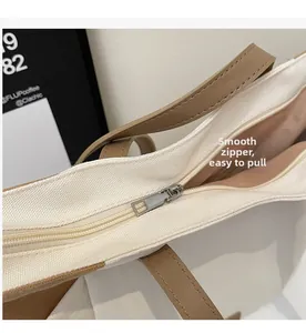 Gedetailleerde close-up van de soepele rits op een grote canvas shopper tas