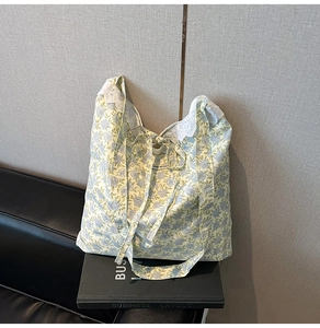 Détail du sac cabas floral avec bordure en dentelle blanche et cordon de serrage en toile