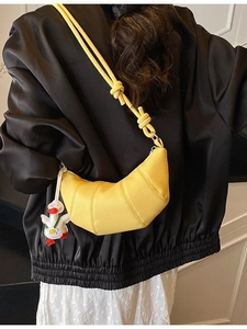 Stylish yellow croissant bag with lychee texture and cute white duck charm for women