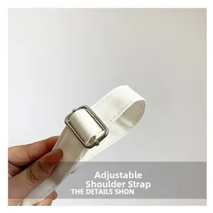 Close-up of adjustable white crocodile pattern PU leather strap with silver metal buckle