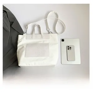 White large-capacity tote bag detail showing crocodile texture and size comparison
