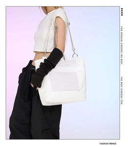White large capacity faux crocodile skin tote bag with silver hardware on a shoulder strap