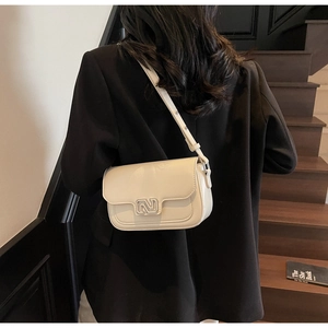 Model view of cream rectangular crossbody bag with silver geometric buckle detail