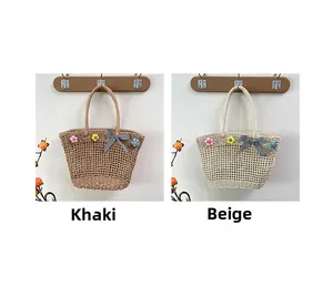 Detail of hollow out straw tote bags with crochet flowers and checkered bow in khaki and beige