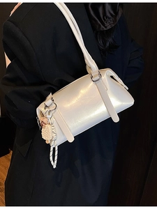 Chic pearl white shoulder bag with glossy finish and cute ice cream charm on model