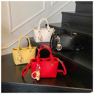 Litchi pattern bucket bags in yellow, white, red, and black with pearl charms