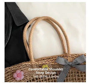 Detail of woven straw tote bag featuring black and white gingham bow and comfortable strap