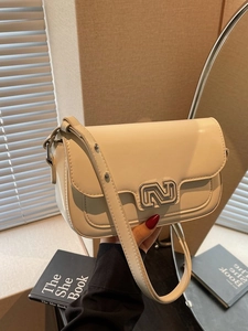 Chic cream white crossbody bag with silver hardware and studded strap for daily fashion