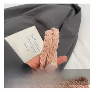 Detailed close-up of a pink woven bucket bag handle with chunky braided texture design