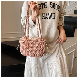 Detail of pink crochet bucket bag with fringe tassel and drawstring lining
